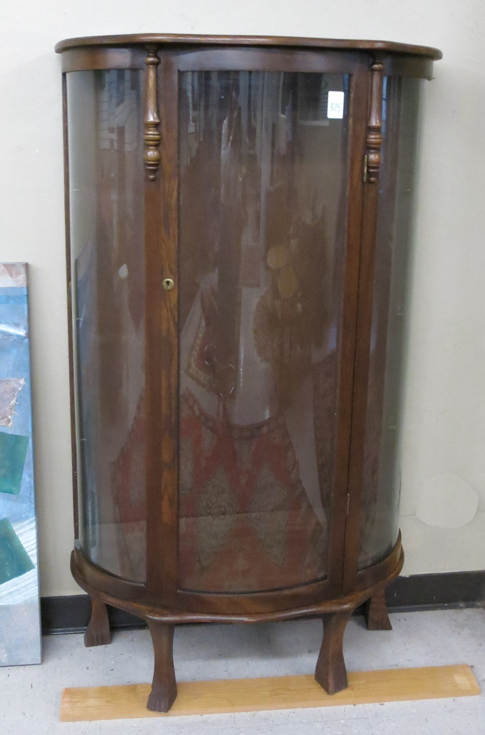 Appraisal: AN OAK AND CURVED GLASS CHINA CABINET American th century