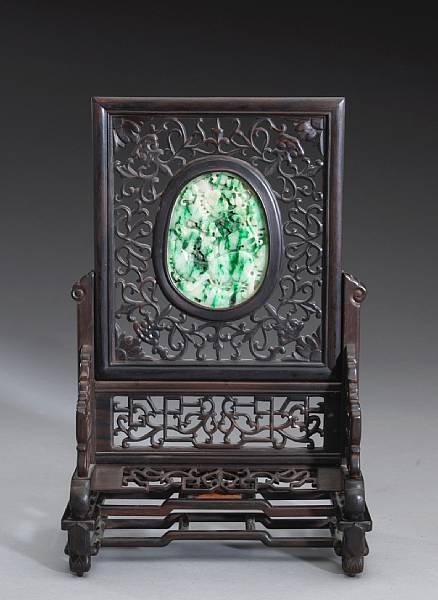 Appraisal: A jadeite-mounted wood table screen The thinly sectioned oval plaque