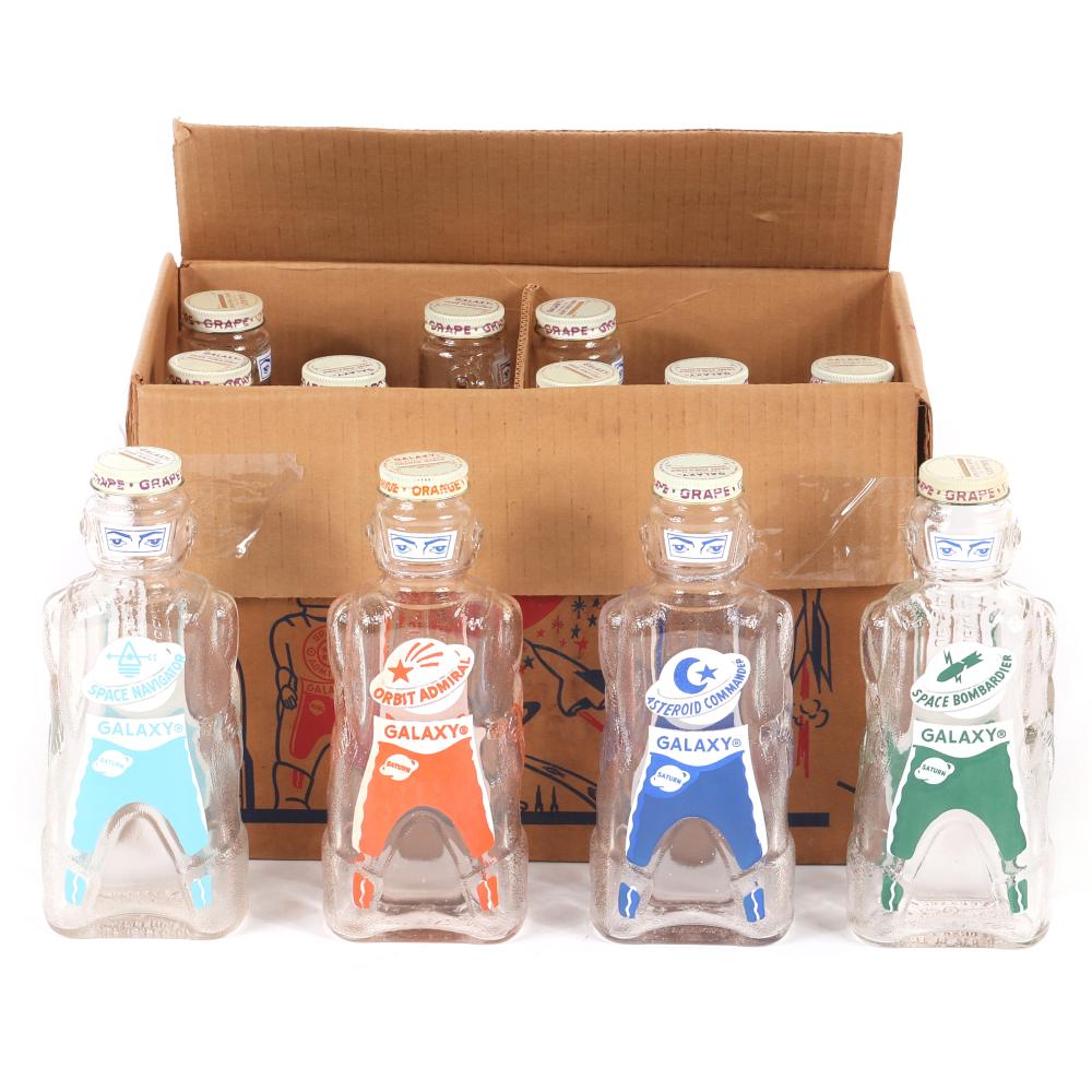 Appraisal: VINTAGE BOX OF TWELVE GALAXY FIGURAL ROBOT GLASS HOME SYRUP