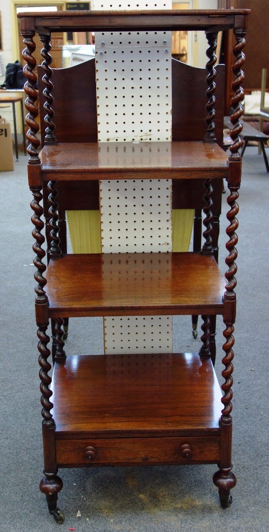 Appraisal: A Victorian rosewood four tier whatnot on barley twist supports