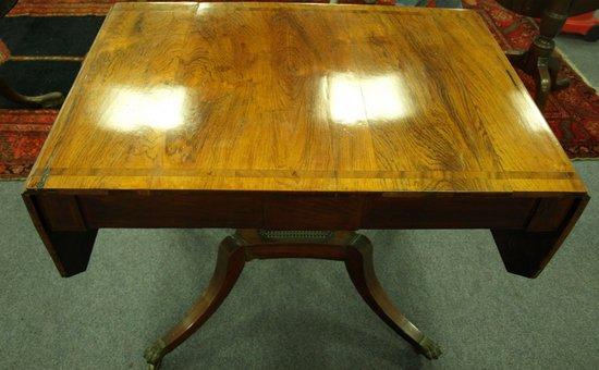 Appraisal: A Regency rosewood two-flap sofa table fitted two drawers on