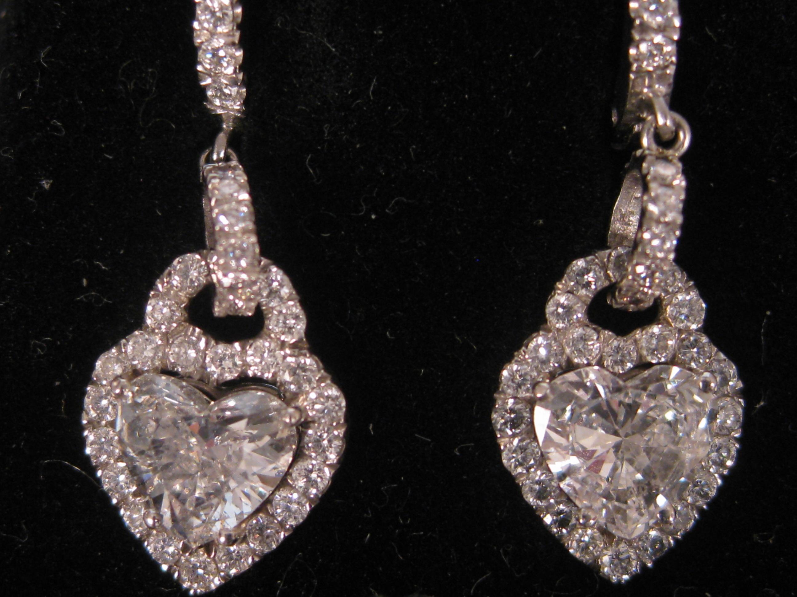 Appraisal: A pair of Diamond Earrings each claw-set with central heart-cut