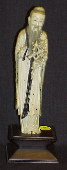 Appraisal: Chinese ivory carving of a standing man holding a peach