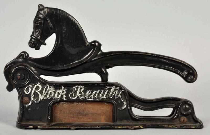 Appraisal: Cast Iron Black Beauty Tobacco Cutter Raised letters spell out