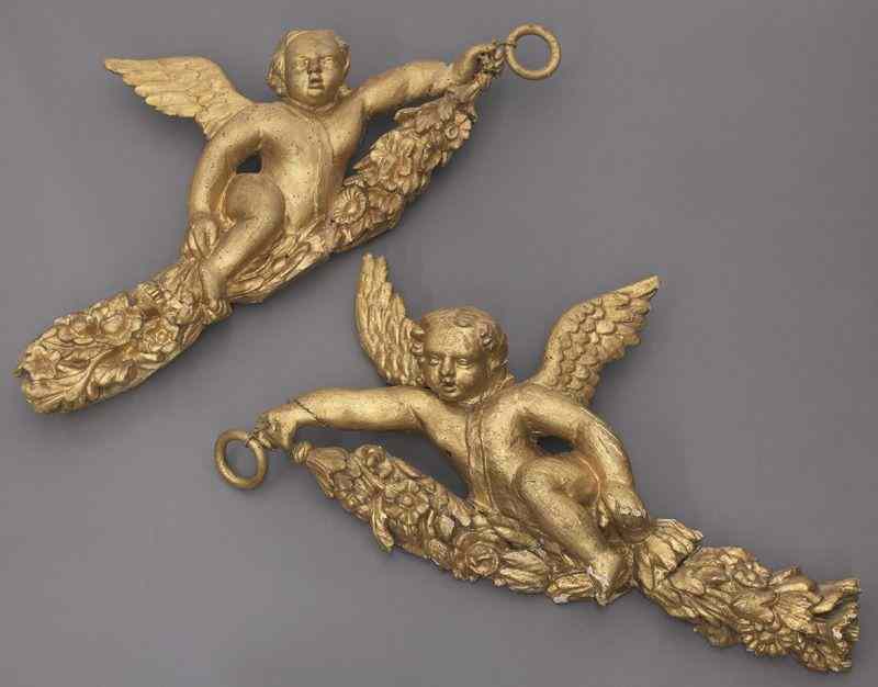 Appraisal: Pr gilt wood wall ornaments carved as puttiin flight each