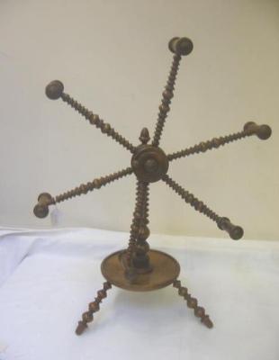 Appraisal: A TREEN WOOL WINDER with six multiple arms supporting bobbins