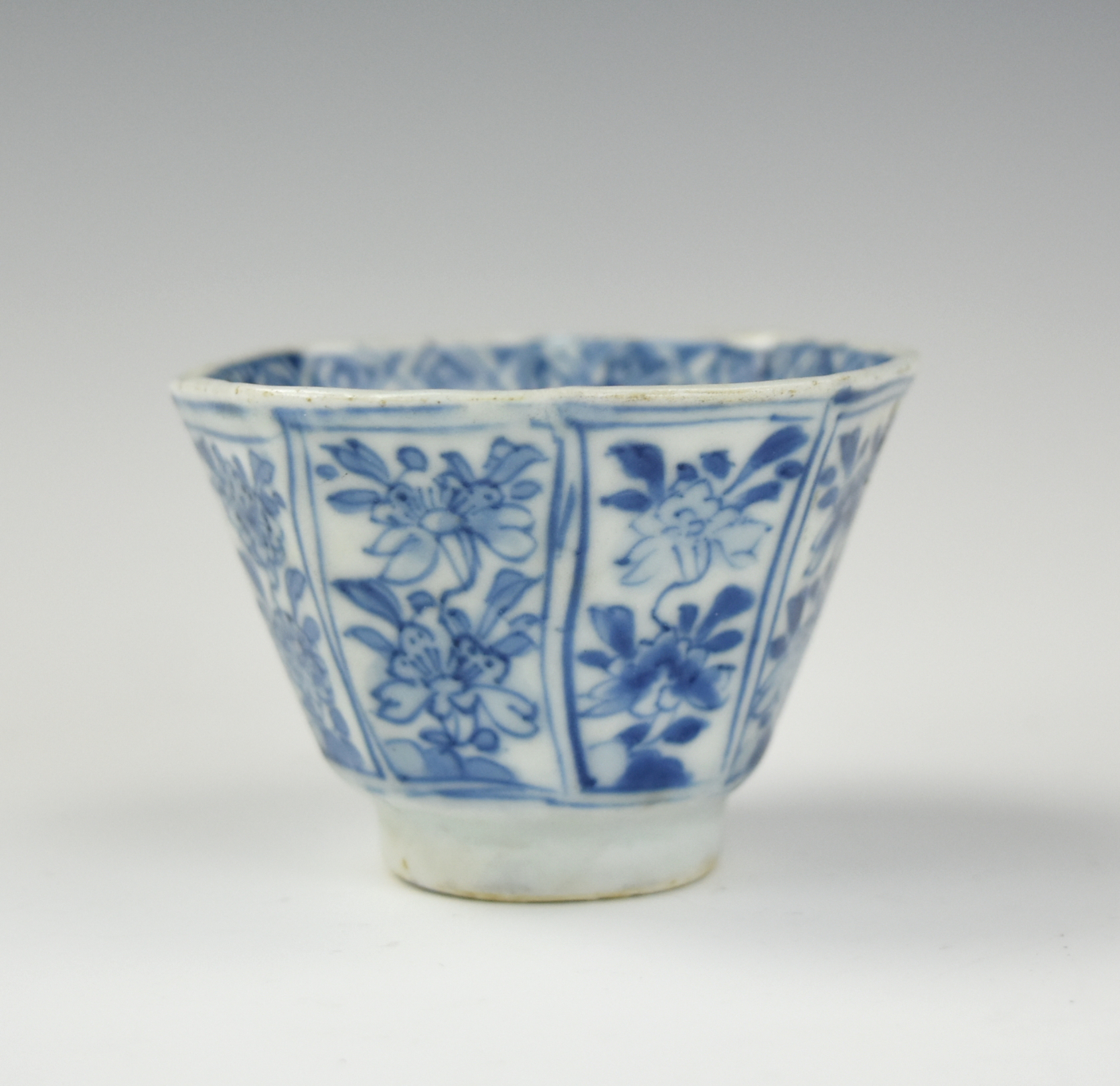 Appraisal: CHINESE B W OCTAGON CUP W FLOWER KANGXI PERIOD Chinese