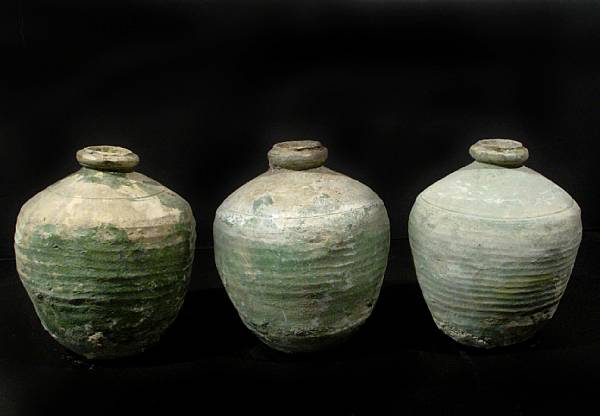 Appraisal: A group of three green glazed terracotta storage jars th