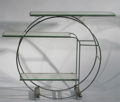 Appraisal: An Art Deco chromed metal and glass display shelf circular