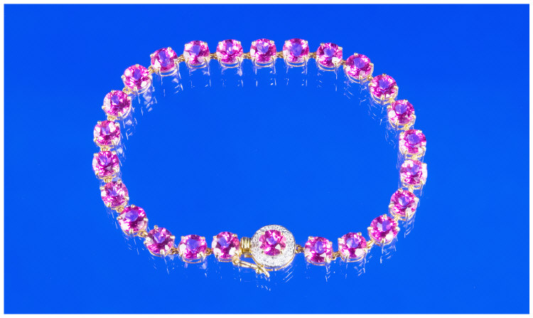 Appraisal: Solid carat gold bracelet set with pink topaz clasp encrusted