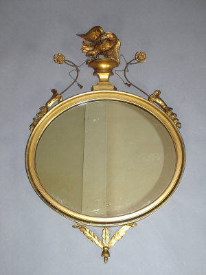 Appraisal: A giltwood circular wall mirror th century the socle mounted