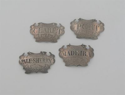 Appraisal: Three George II escutcheon labels with chased vine borders incised