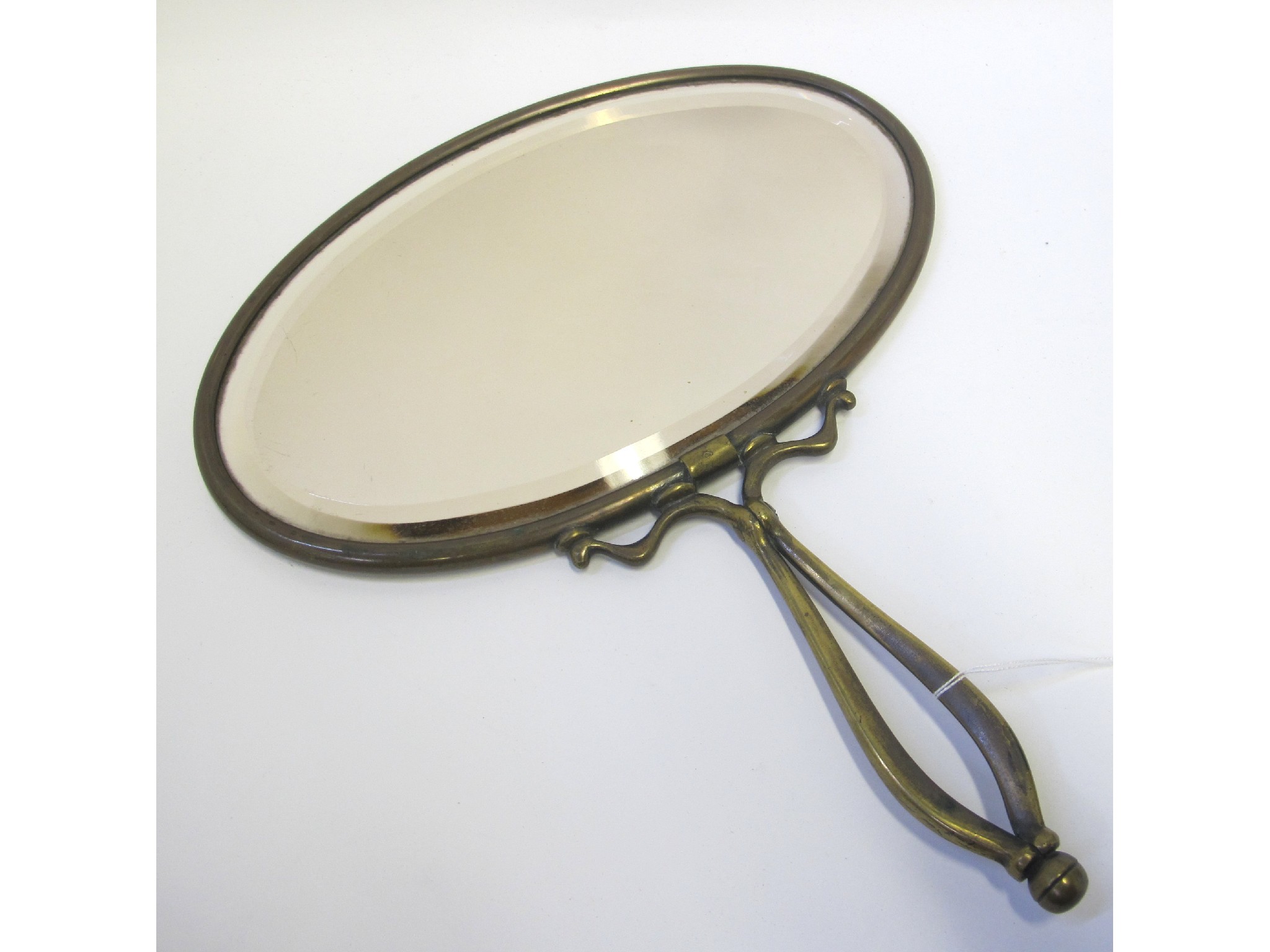 Appraisal: Patinated metal handheld mirror in the manner of W A