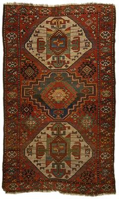 Appraisal: Kazak rug three central medallions on red field geometric borders