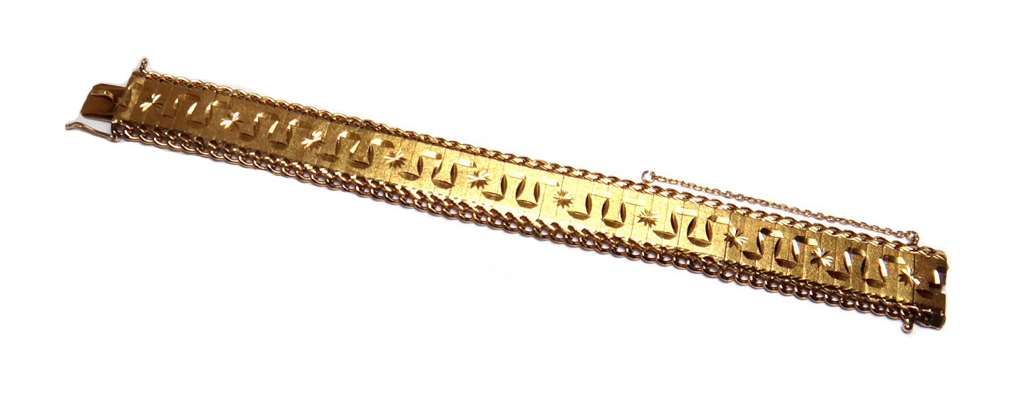 Appraisal: A gold wide link bracelet with facet cut decoration decorated