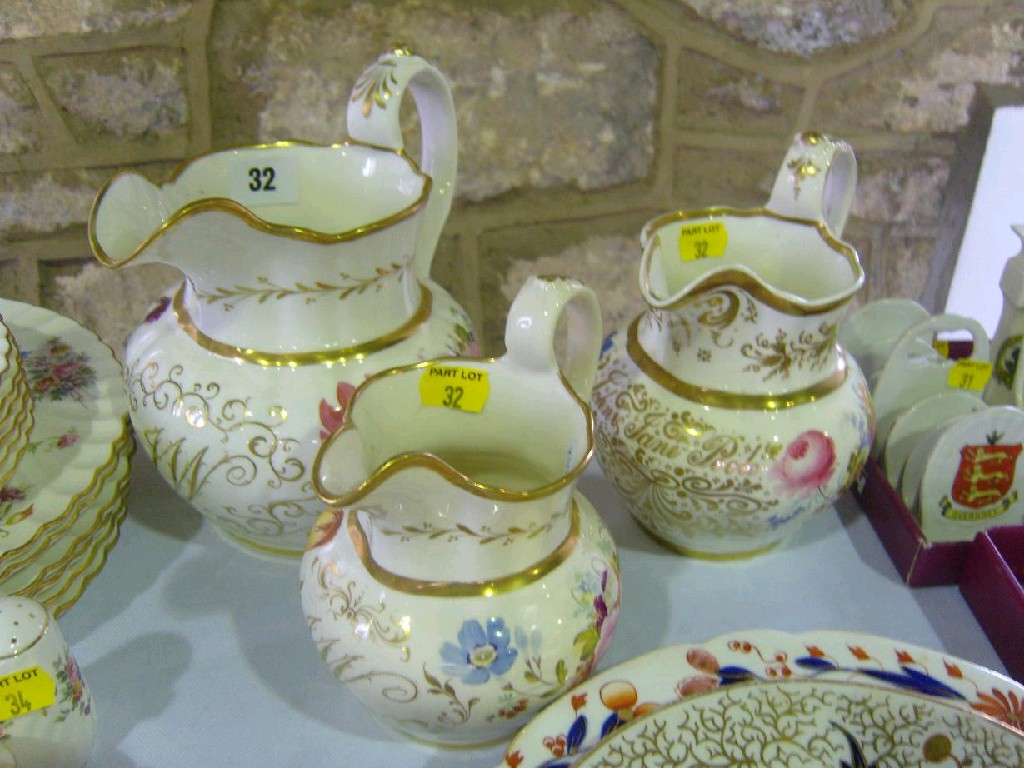 Appraisal: Two graduated th century jugs with painted floral sprays both