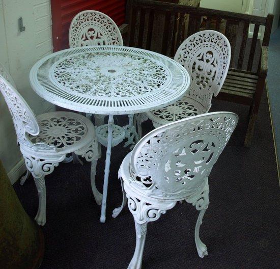 Appraisal: A set of four cast and painted garden chairs a