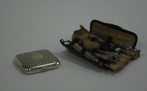 Appraisal: A silver cigarette case CC Birmingham with scrolling decoration throughout