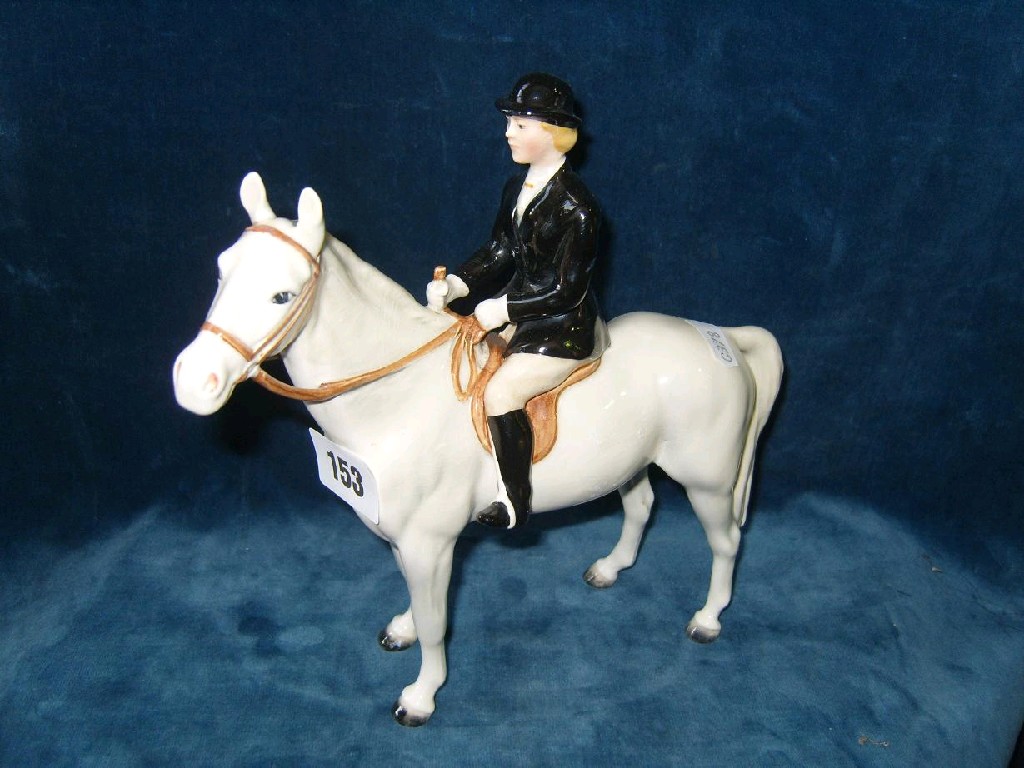 Appraisal: A Beswick model of a black jacketed huntswoman seated astride