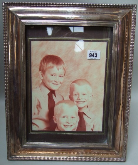 Appraisal: A large rectangular photograph frame decorated with a ridged border