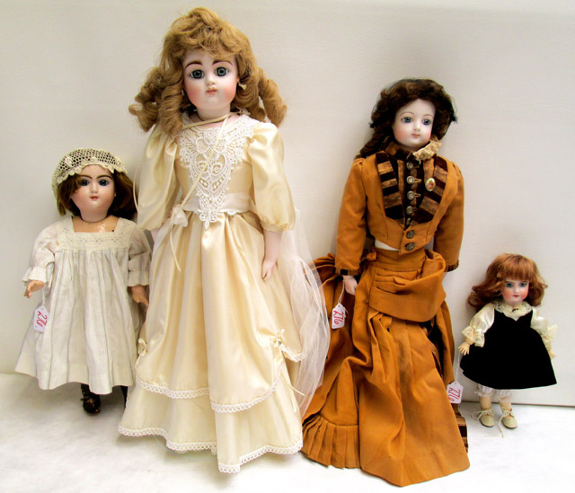 Appraisal: FOUR REPRODUCTION BISQUE HEAD DOLLS all socket heads having fixed