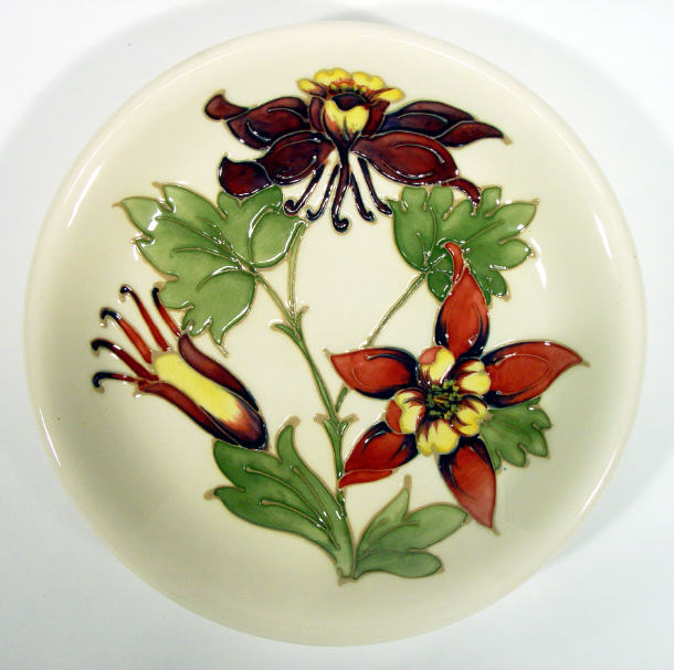 Appraisal: Moorcroft pottery plate hand painted and tubelined with orchids onto