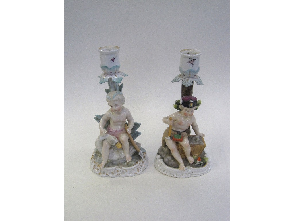 Appraisal: Pair of Sitzendorf porcelain candlesticks each with a putti and