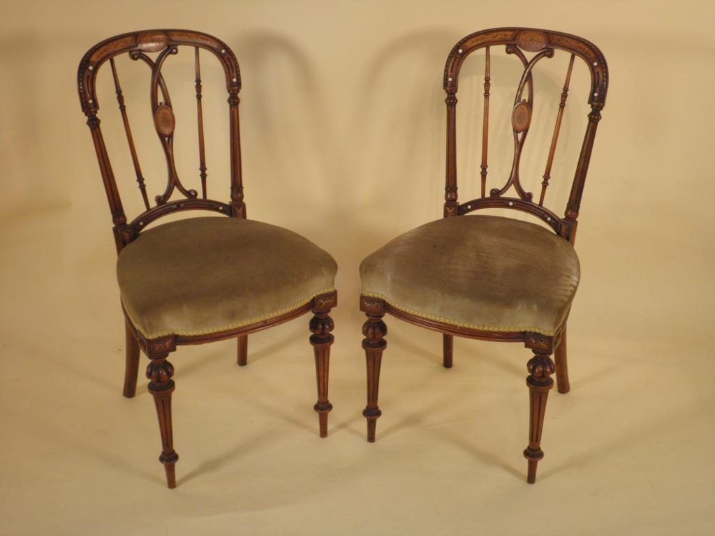 Appraisal: A pair of Victorian walnut and marquetry side chairs each