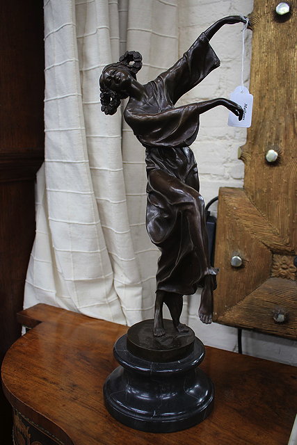 Appraisal: A CONTEMPORARY BRONZE SCULPTURE OF A DANCING GIRL her hair