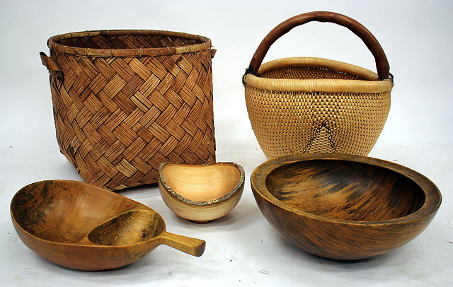 Appraisal: A LARGE WICKER BASKET of curved form with wooden handle