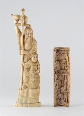 Appraisal: A Japanese walrus ivory carving of a standing figure holding