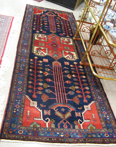 Appraisal: PERSIAN HALL CARPET Hamadan tribal central geometric medallion and stylized