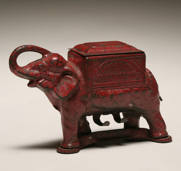 Appraisal: Cast iron elephant mechanical roller dispenser crackled red paint with