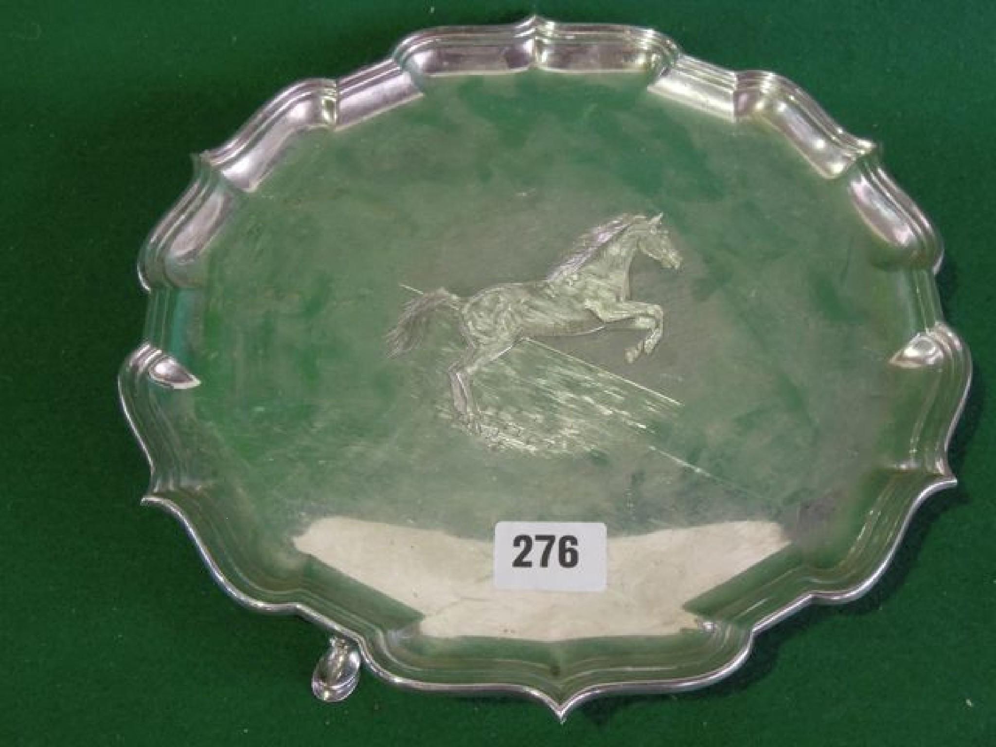 Appraisal: A Georgian style salver with a shaped border on hoof