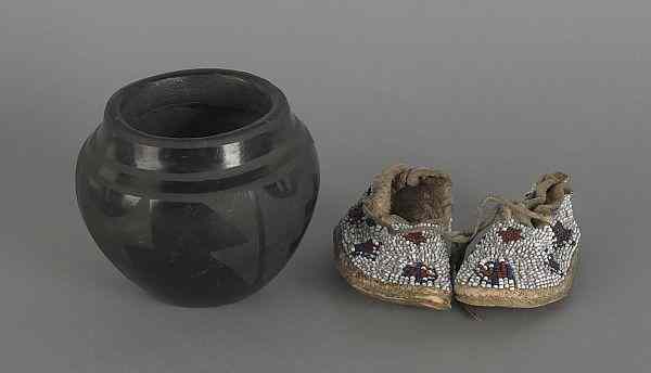 Appraisal: Santa Clara blackware pot h together with beaded infant moccasins