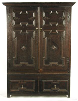 Appraisal: A panelled oak hanging cupboard with a moulded cornice above