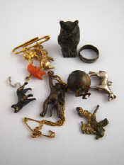 Appraisal: A quantity of charms including two yellow metal tests carat