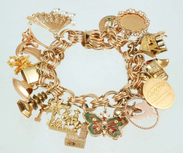 Appraisal: Charm bracelet Marked K yellow gold bracelet with twenty-two charms