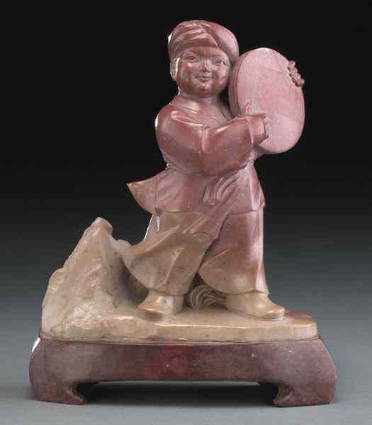 Appraisal: Chinese Cultural Revolution soapstone carvingdepicting a boy holding a drum