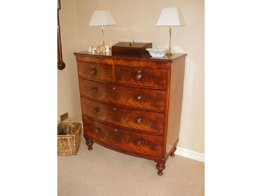 Appraisal: A Victorian flamed mahogany bow front chest with knob handles