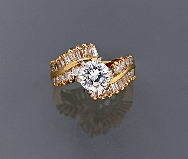 Appraisal: A diamond ring centering a round brilliant-cut diamond principal diamond