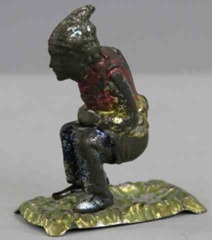 Appraisal: SEATED MAN PENNY TOY Germany spirit painted whimsical example of