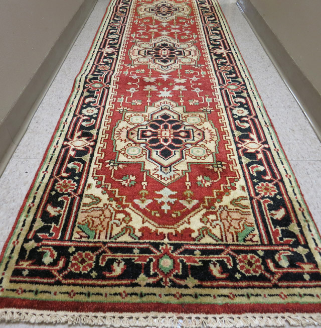 Appraisal: HAND KNOTTED ORIENTAL CORRIDOR CARPET Indo-Persian having eight geometric medallions