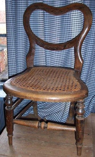 Appraisal: A child's Victorian buckle back chair the faux rosewood frame