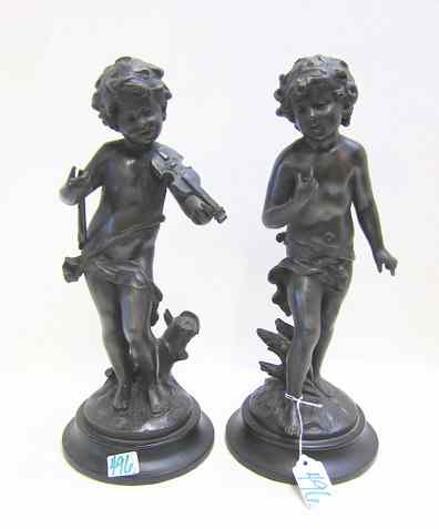 Appraisal: SET OF TWO BRONZE FIGURAL PUTTI SCULPTURES one playing violin