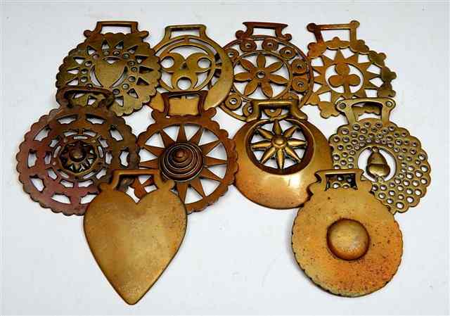 Appraisal: A COLLECTION OF TEN OLD HORSE BRASSES with pierced decoration