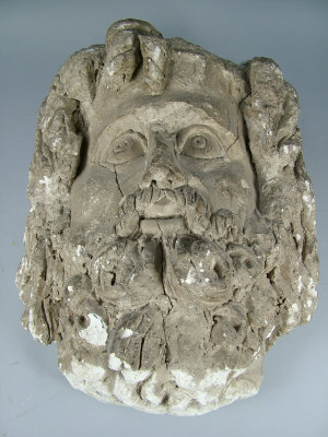 Appraisal: A reconstituted carved stone fragment depicting the face of a