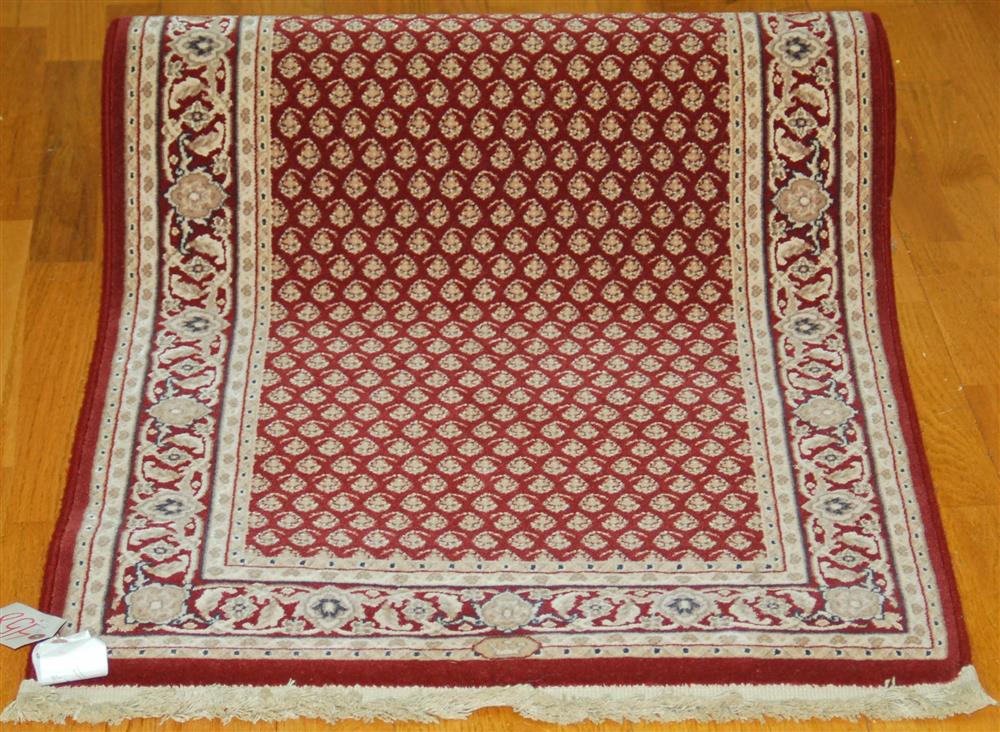 Appraisal: KARASTAN RUNNER having a red field with an ivory paisley