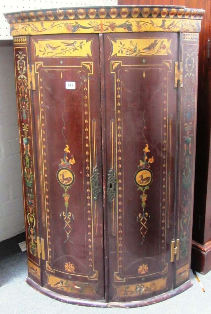 Appraisal: A George III mahogany bowfront two door corner cupboard later