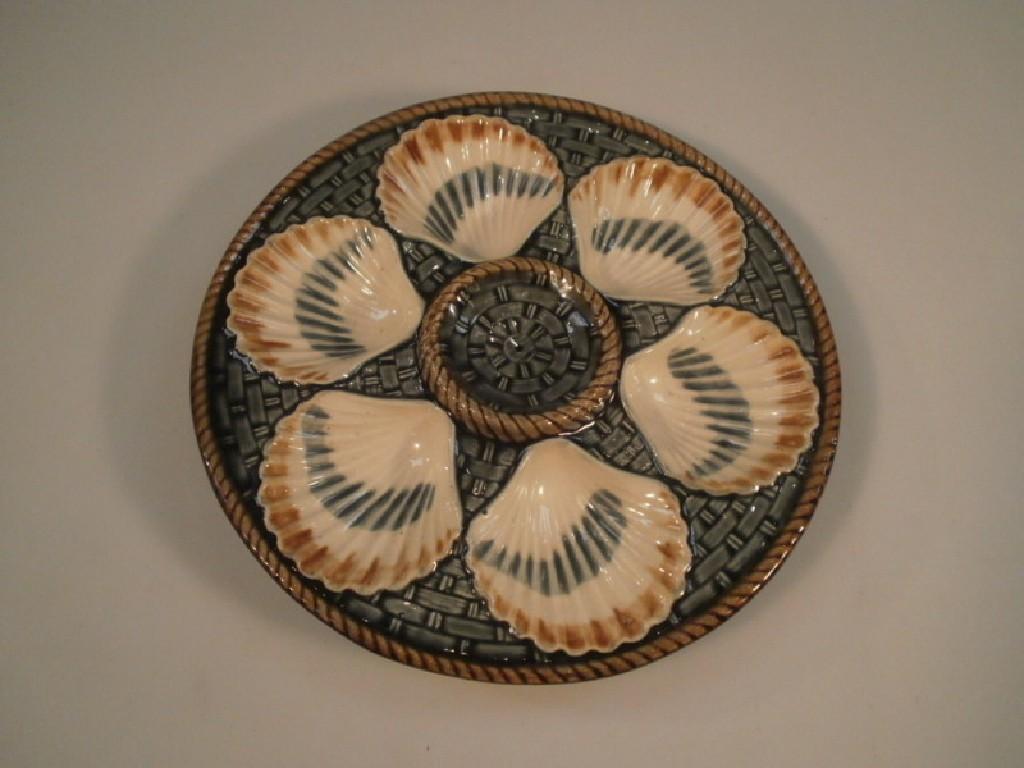 Appraisal: A continental majolica clam dish decorated with stylized basket weave